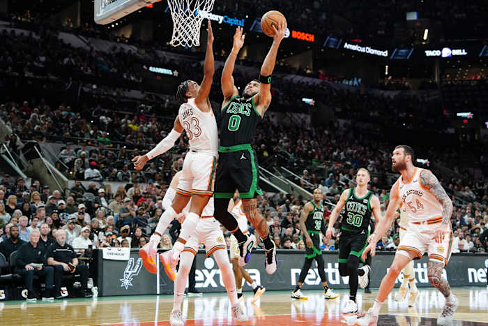 Dec 31, 2023; San Antonio, Texas, USA; Boston Celtics forward Jayson Tatum (0) shoots over San Antonio Spurs guard Tre Jones (33) in the first half at Frost Bank Center.
